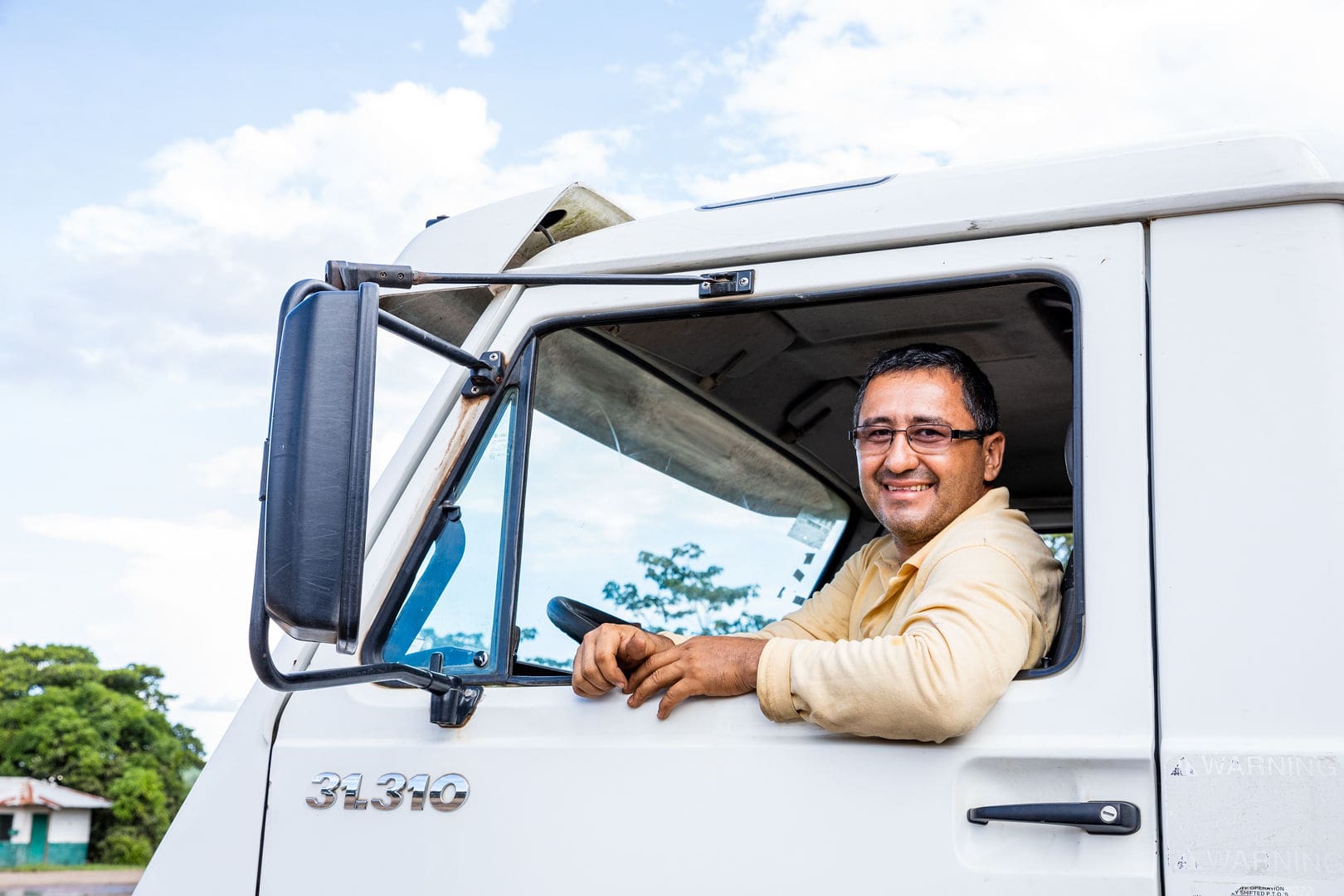 Truck-driver-smiling-through-vehicle-window